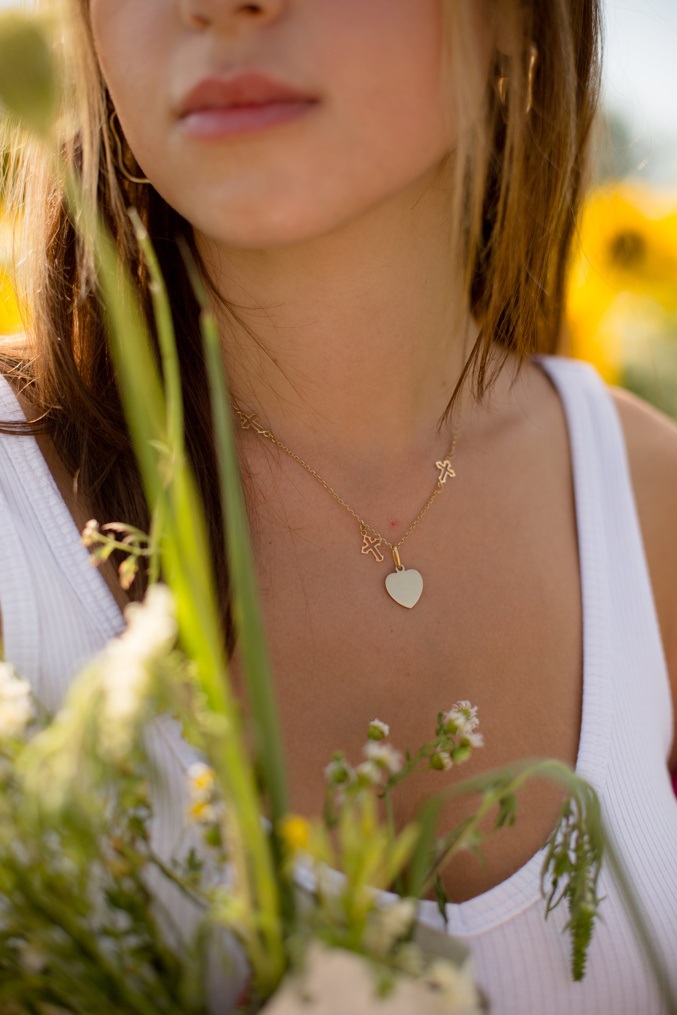 close-up-of-a-gold-necklace-on-a-person-in-a-white-shirt.jpg